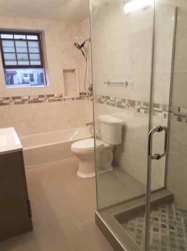 Glass shower door bathroom remodel by Shaara Contracting Inc